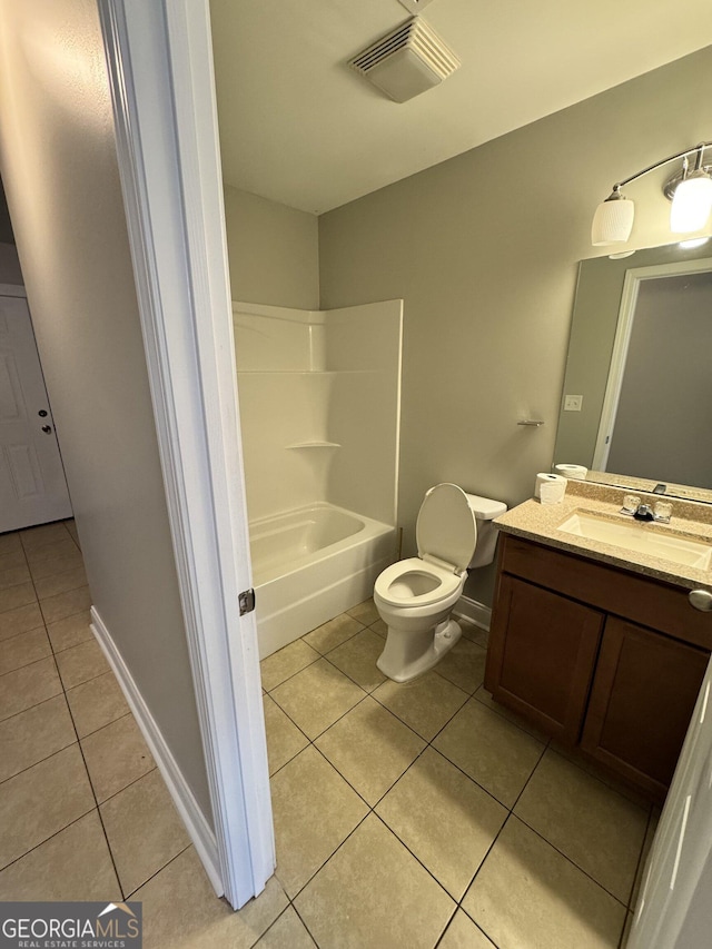 full bathroom featuring washtub / shower combination, toilet, tile patterned flooring, and vanity