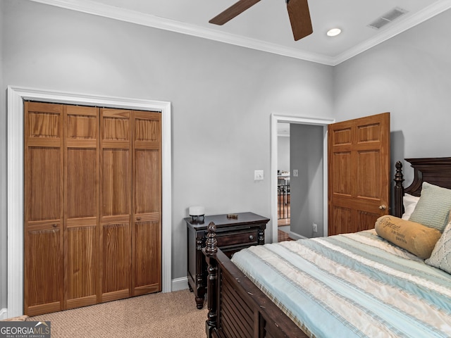 bedroom featuring ceiling fan, light colored carpet, a closet, and ornamental molding