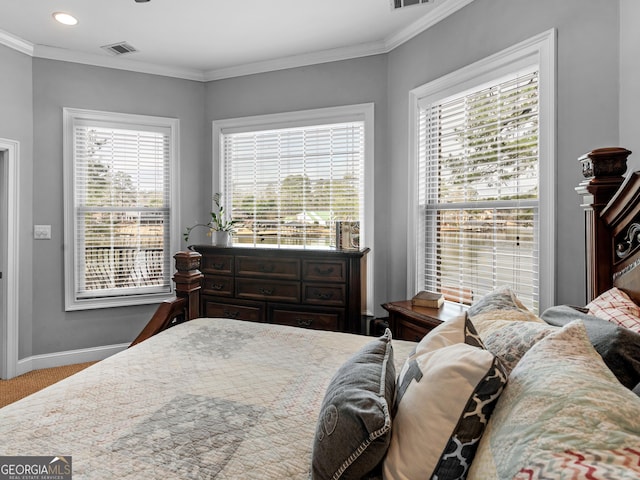 carpeted bedroom featuring crown molding