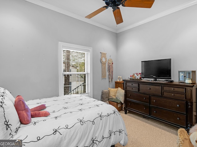 carpeted bedroom featuring ceiling fan and crown molding