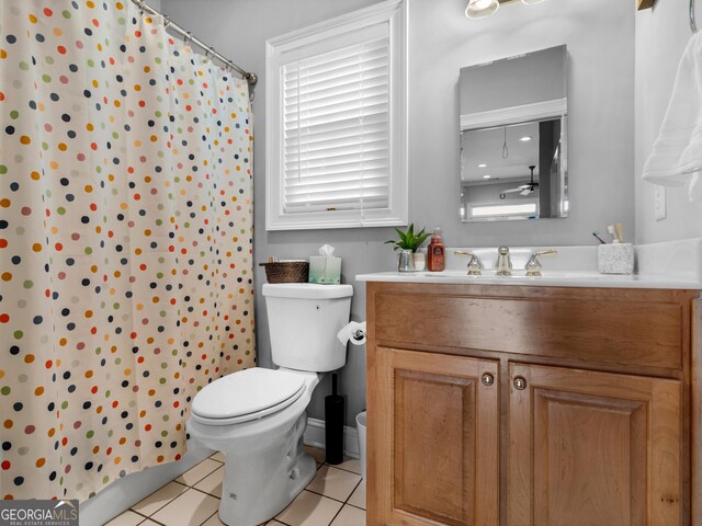 bathroom featuring toilet, vanity, a shower with shower curtain, and tile patterned flooring