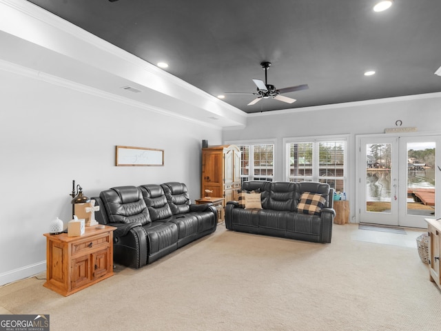 carpeted living room featuring ceiling fan and ornamental molding