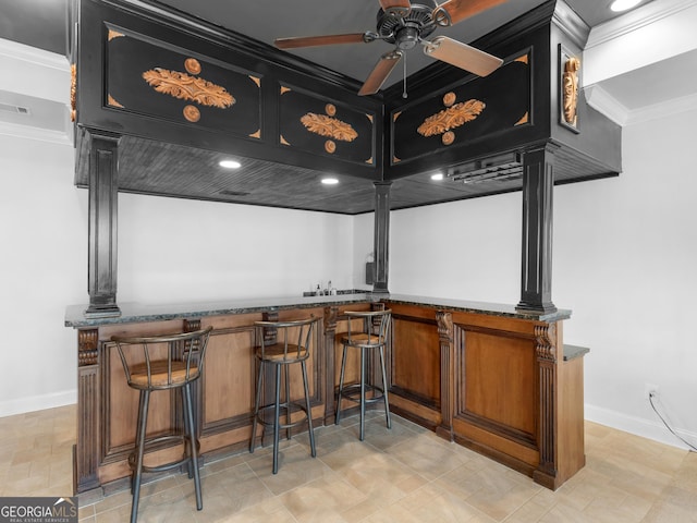 bar with ceiling fan, crown molding, and dark stone countertops