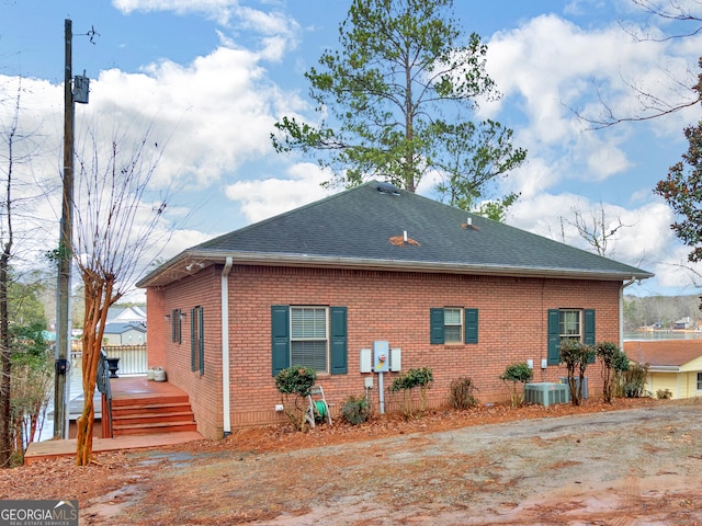 view of property exterior with central AC unit and a wooden deck