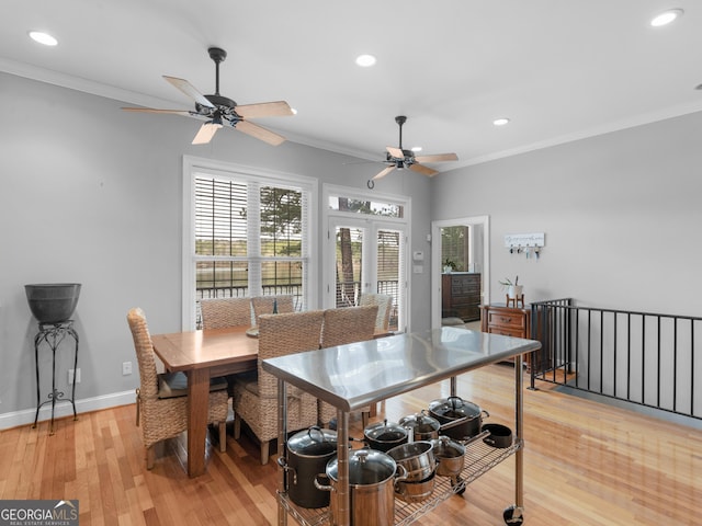 dining space with french doors, crown molding, and light hardwood / wood-style flooring