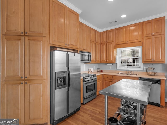 kitchen featuring light hardwood / wood-style floors, sink, crown molding, and stainless steel appliances