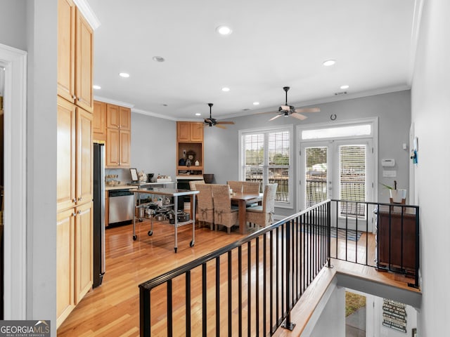 hallway with light hardwood / wood-style floors and crown molding