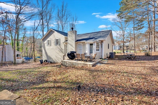 rear view of property featuring central AC and a patio