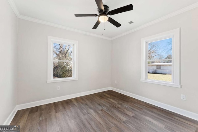 unfurnished room featuring crown molding, dark wood-type flooring, and a wealth of natural light