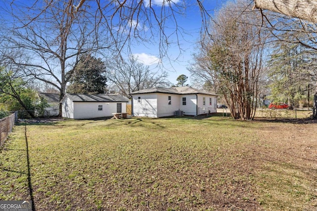 view of yard featuring central AC and a storage shed