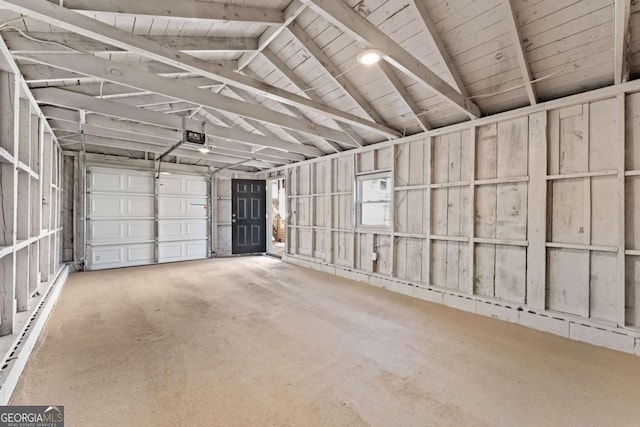 garage with a garage door opener, wooden walls, and baseboard heating