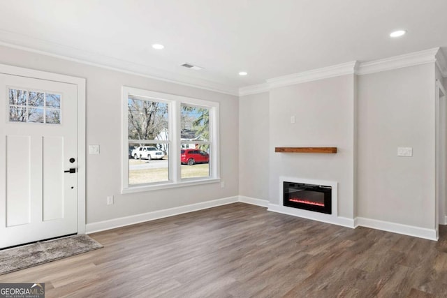 unfurnished living room featuring dark wood-type flooring and ornamental molding