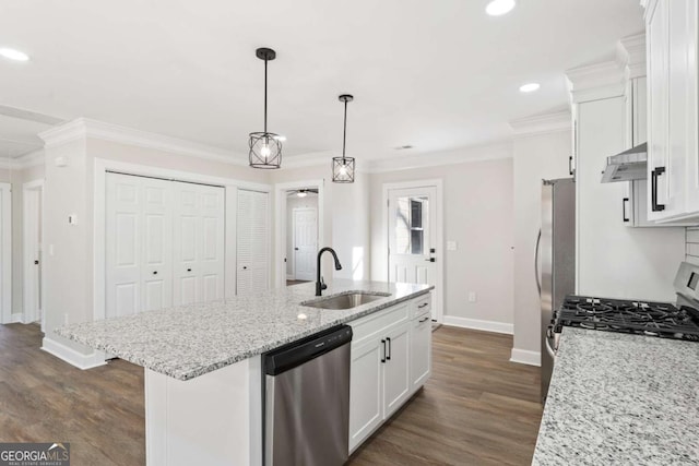 kitchen with sink, white cabinetry, light stone counters, a center island with sink, and appliances with stainless steel finishes