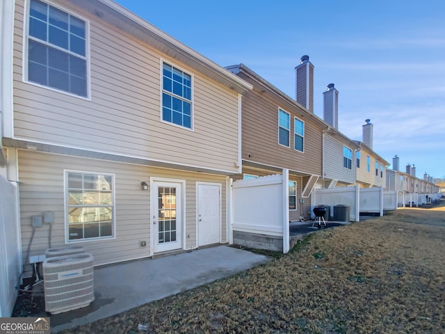 rear view of house with a patio area and cooling unit