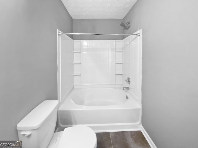 bathroom featuring toilet, a textured ceiling, and  shower combination