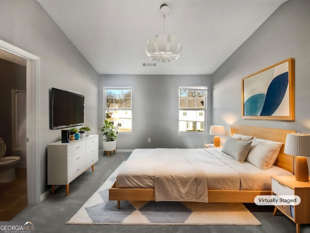 bedroom with lofted ceiling and dark colored carpet