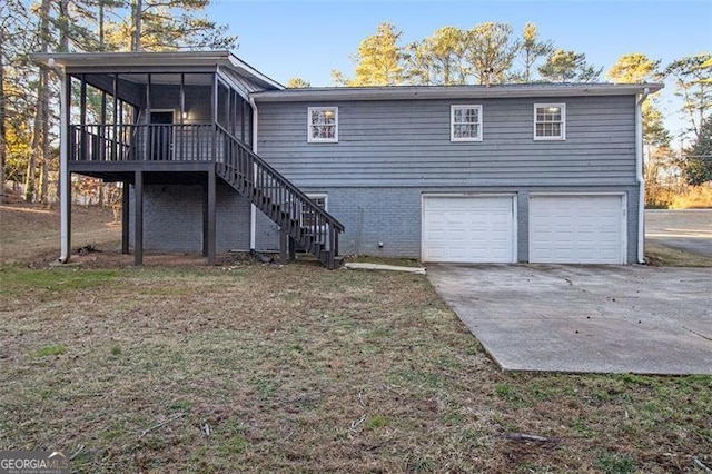 back of house featuring a garage and a sunroom