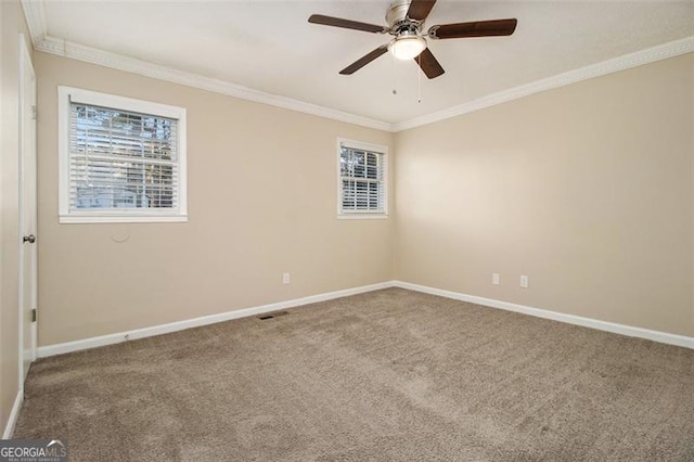 carpeted spare room with ceiling fan and crown molding