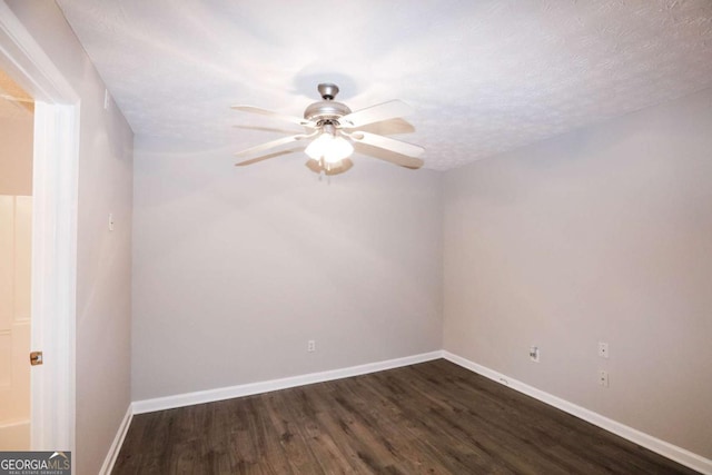 spare room with ceiling fan, dark hardwood / wood-style floors, and a textured ceiling