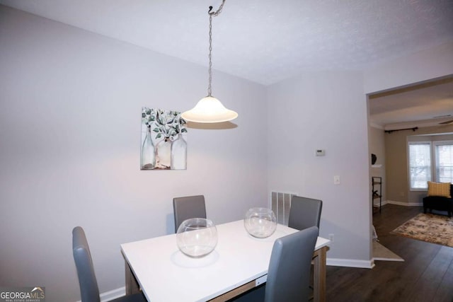 dining space with dark wood-type flooring