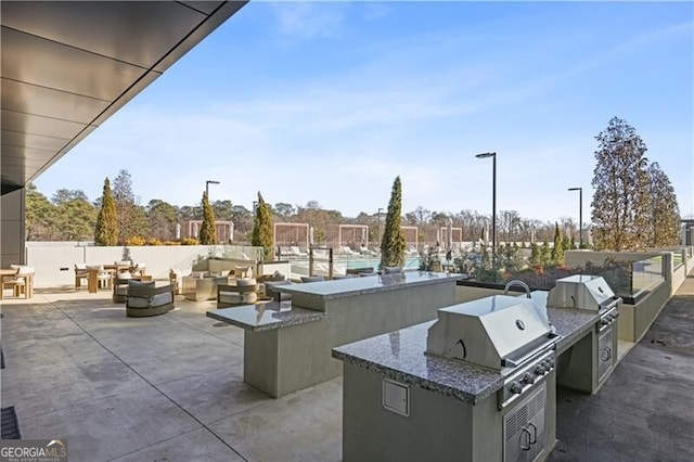 view of patio / terrace featuring grilling area, an outdoor kitchen, and an outdoor hangout area