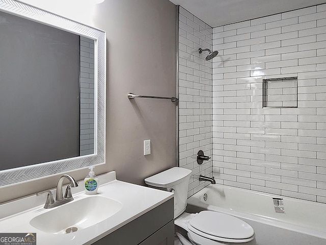 full bathroom featuring toilet, tiled shower / bath combo, and vanity