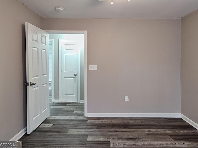 unfurnished room featuring dark wood-type flooring