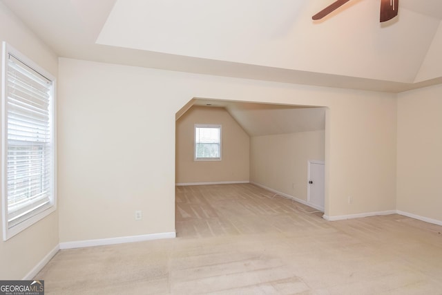 bonus room with light carpet, ceiling fan, and vaulted ceiling