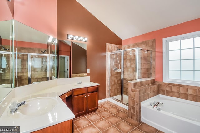 bathroom featuring tile patterned floors, vanity, lofted ceiling, and independent shower and bath