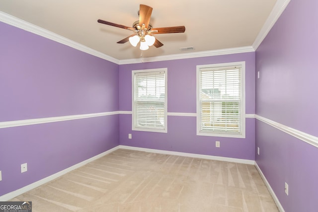 carpeted empty room with ceiling fan and crown molding