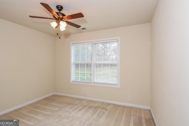 unfurnished room featuring light carpet and ceiling fan