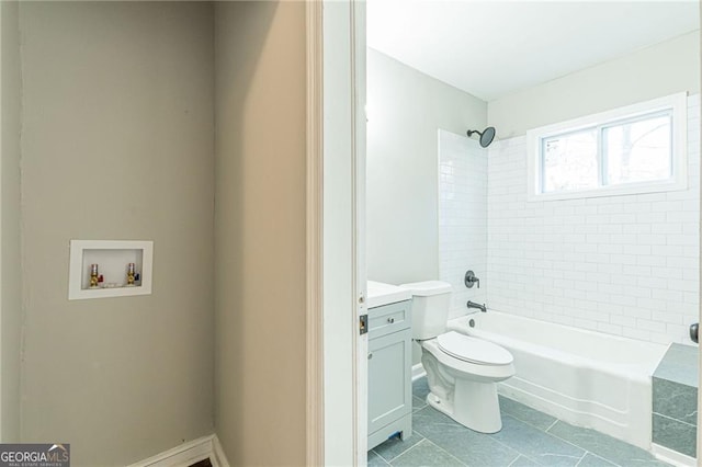 full bathroom featuring tiled shower / bath combo, vanity, tile patterned flooring, and toilet