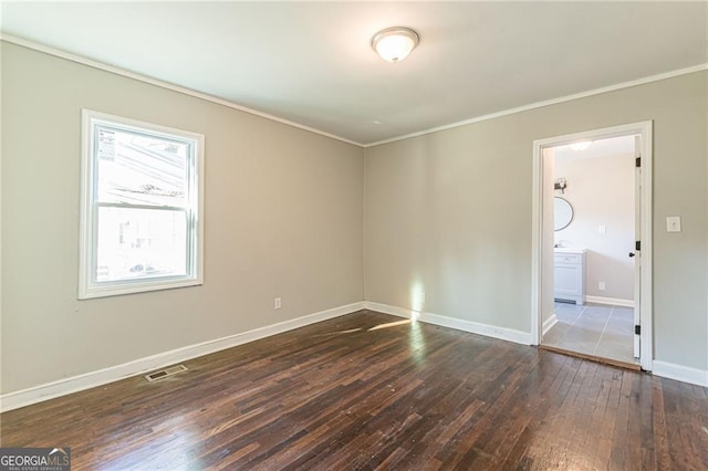 empty room with crown molding and dark wood-type flooring