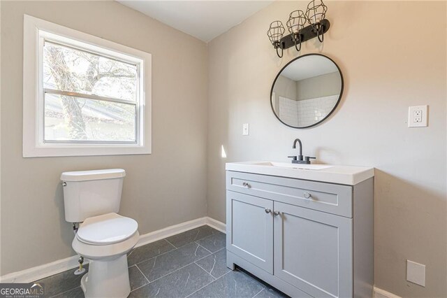 bathroom featuring vanity and toilet