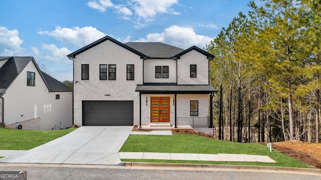 view of front of home featuring a garage and a front lawn