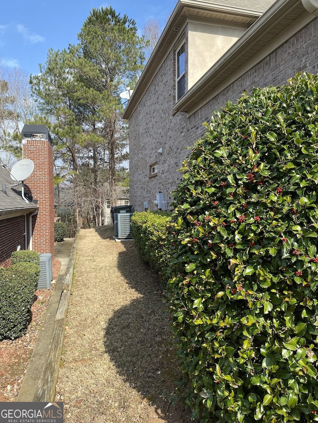 view of side of property featuring central AC