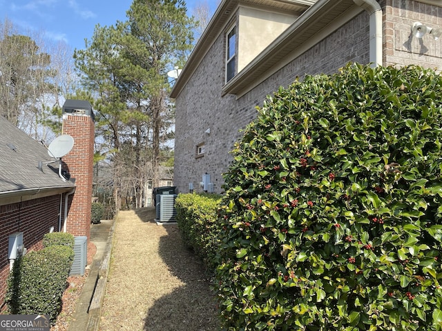 view of side of home with central AC unit