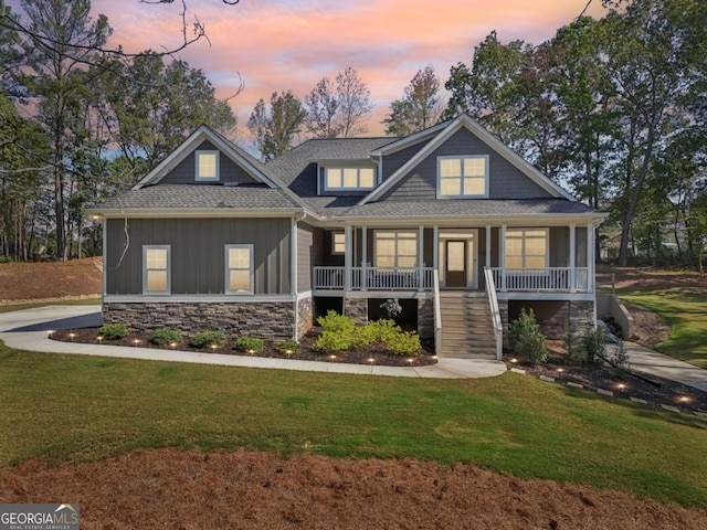 craftsman-style home with a yard and covered porch