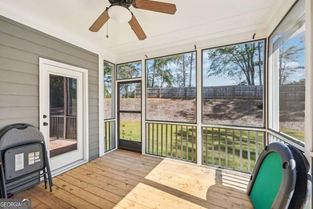 sunroom / solarium featuring ceiling fan