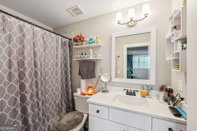 bathroom with toilet, vanity, and a shower with curtain