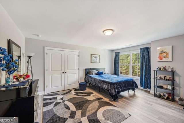 bedroom with a closet and light hardwood / wood-style flooring