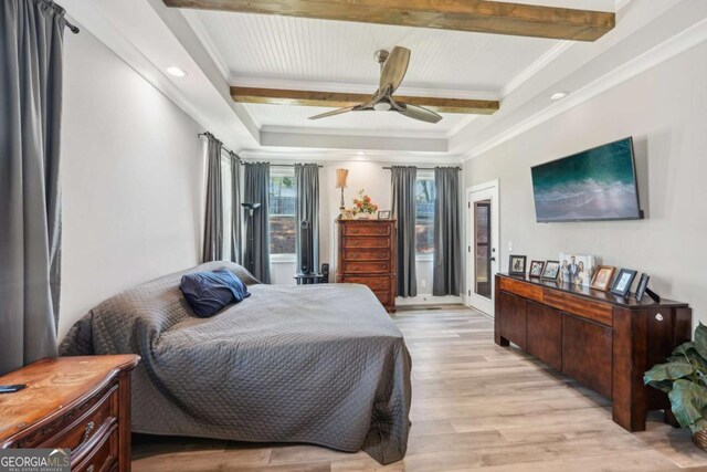 bedroom featuring ceiling fan, beamed ceiling, crown molding, and light hardwood / wood-style flooring