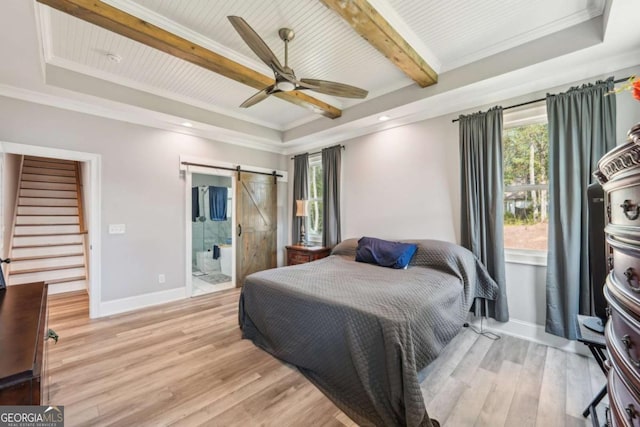 bedroom featuring ensuite bath, light hardwood / wood-style floors, ceiling fan, beam ceiling, and a barn door