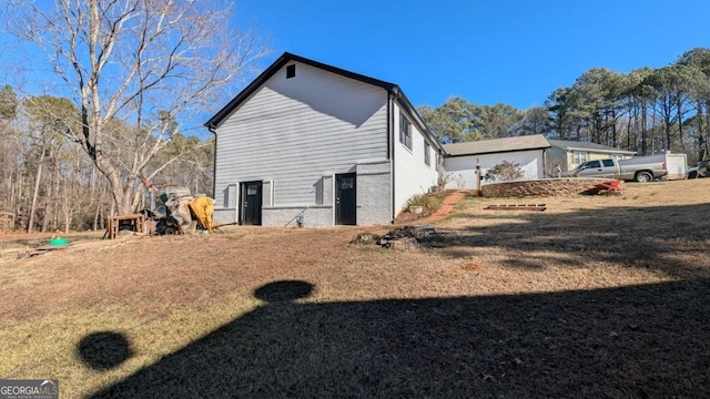 rear view of property featuring a yard