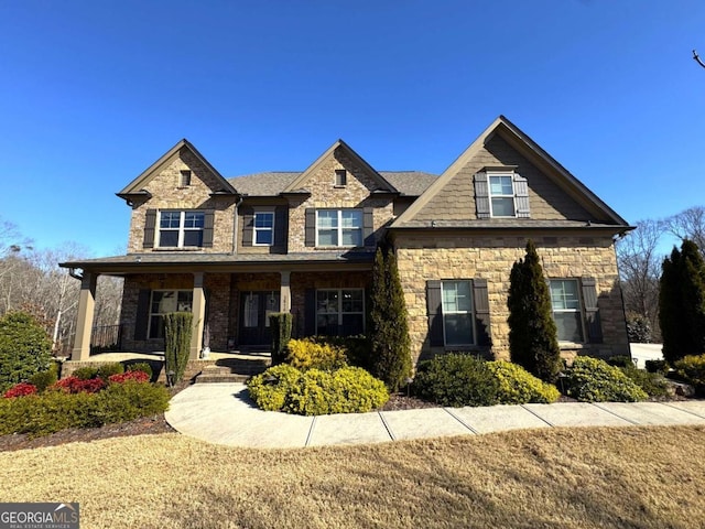 view of front of house with covered porch and a front lawn