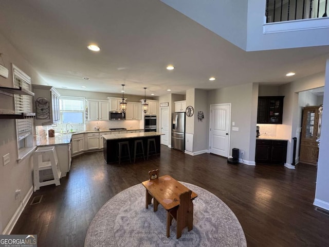 living room featuring dark wood-type flooring and sink