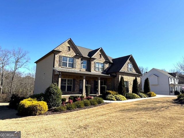 craftsman house with covered porch and a front lawn