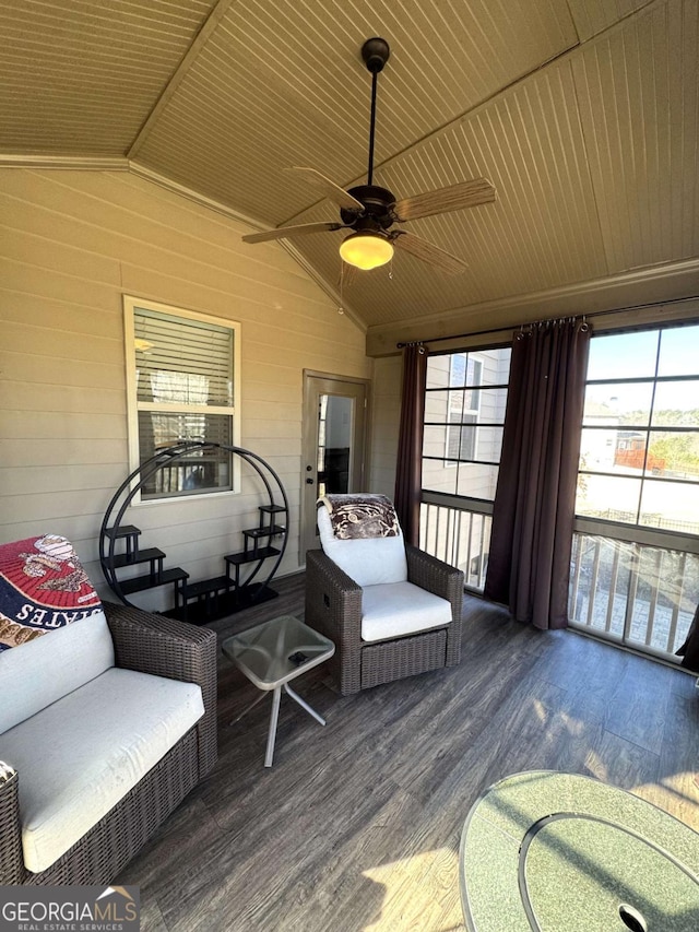 sunroom / solarium with ceiling fan, lofted ceiling, and wood ceiling