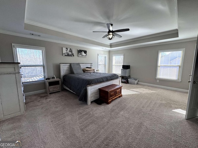 bedroom with ceiling fan, ornamental molding, a raised ceiling, and carpet flooring