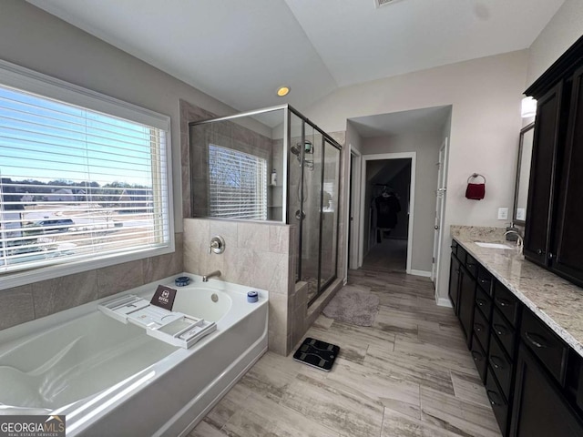 bathroom featuring vanity and shower with separate bathtub